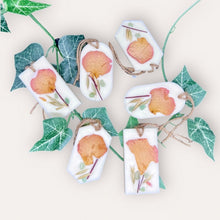 Load image into Gallery viewer, Refreshe Sachets by Pure Essence Scent-white scented wax decorated with dried botanicals and pebbles for decoration, and twine loop for hanging.