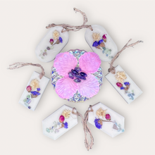 Load image into Gallery viewer, Blooming Flowers Sachets by Pure Essence Scent-white scented wax decorated with dried botanicals and pebbles for decoration, and twine loop for hanging.