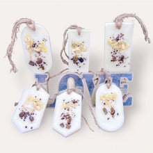 Load image into Gallery viewer, Cozy Nights Sachets by Pure Essence Scent-white scented wax decorated with ground coffee and pebbles for decoration, and twine loop for hanging.
