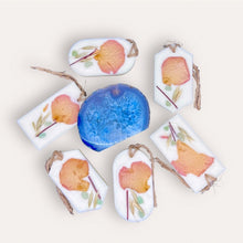 Load image into Gallery viewer, Refreshe Sachets by Pure Essence Scent-white scented wax decorated with dried botanicals and pebbles for decoration, and twine loop for hanging.