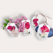 Load image into Gallery viewer, Lovely Garden Sachets by Pure Essence Scent-white scented wax decorated with dried botanicals and pebbles for decoration, and twine loop for hanging.