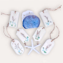 Load image into Gallery viewer, Calming Creek Sachets by Pure Essence Scent-white scented wax decorated with dried botanicals and pebbles for decoration, and twine loop for hanging.