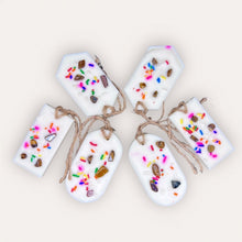 Load image into Gallery viewer, Cozy Nights Sachets by Pure Essence Scent-white scented wax decorated with colorful sprinkles and pebbles for decoration, and twine loop for hanging.