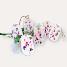 Load image into Gallery viewer, Cozy Nights Sachets by Pure Essence Scent-white scented wax decorated with colorful sprinkles and pebbles for decoration, and twine loop for hanging.