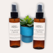 Load image into Gallery viewer, Calming Creek Room and Linen Spray by Pure Essence Scent-Amber plastic spray bottles filled with scented liquid.