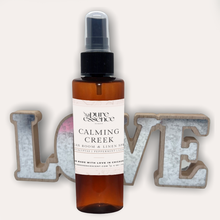 Load image into Gallery viewer, Calming Creek Room and Linen Spray by Pure Essence Scent-Amber plastic spray bottles filled with scented liquid.