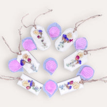 Load image into Gallery viewer, Blooming Flowers Sachets by Pure Essence Scent-white scented wax decorated with dried botanicals and pebbles for decoration, and twine loop for hanging.