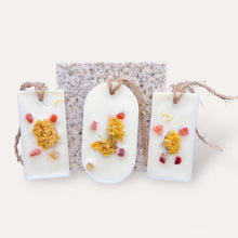 Load image into Gallery viewer, Pleasant Sunshine Sachets by Pure Essence Scent-white scented wax decorated with dried botanicals and pebbles for decoration, and twine loop for hanging.