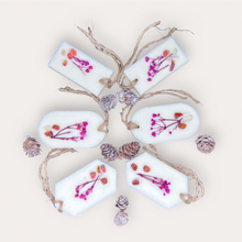 Load image into Gallery viewer, Pomegranade Sachets by Pure Essence Scent-white scented wax decorated with dried botanicals and pebbles for decoration, and twine loop for hanging.