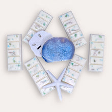 Load image into Gallery viewer, Calming Creek Wax Melts by Pure Essence Scent—white scented wax decorated with dried botanicals and decorative pebbles.