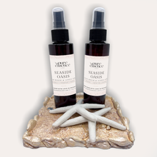 Load image into Gallery viewer, Seaside Oasis Room and Linen Spray by Pure Essence Scent-Amber plastic spray bottles filled with scented liquid.